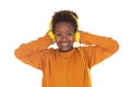 African boy listening music in yellow headphones