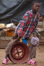 African boy on wheel rim Royalty Free Stock Photo