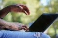 African male working with the laptop in a park. Black man digital nomad