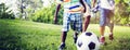African Brother Playing Football Outdoors Concept