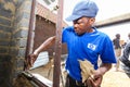 African builder installing windows on a Community Outreach program to build a small affordable house in local township