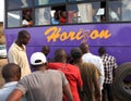 African Bus Passengers Watching the Tire Get Fixed