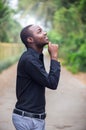 African business man looking and thinking in green nature background Royalty Free Stock Photo