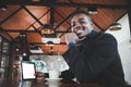 African business man using tablet and having a happy time with good idea thinking in coffee shop Royalty Free Stock Photo