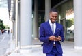 African business man walking and looking at mobile phone Royalty Free Stock Photo