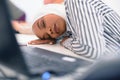 African business muslim woman sitting at her desk and sleeping isolated on white background Royalty Free Stock Photo