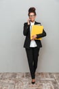 African business woman standing over grey wall Royalty Free Stock Photo