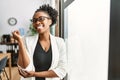 African business woman working at the office smiling happy pointing with hand and finger to the side Royalty Free Stock Photo