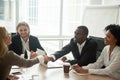 African businessman and caucasian businesswoman shaking hands at Royalty Free Stock Photo