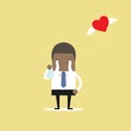 African businessman crying broken heart with heart flying away. Royalty Free Stock Photo