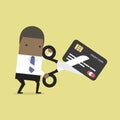 African businessman cutting credit card. Royalty Free Stock Photo