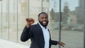 African businessman dancing in city. Business man celebrating success on street. Royalty Free Stock Photo