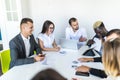 African businessman explaining sales graph to colleagues in meeting. Project summ Royalty Free Stock Photo