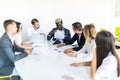 African businessman explaining sales graph to colleagues in meeting. Project summ Royalty Free Stock Photo