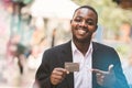 African businessman holding and showing business card. Adult black man wearing formal suit Royalty Free Stock Photo