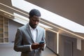 African Businessman Holding Smartphone in Grey Office Royalty Free Stock Photo