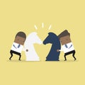 African businessman with horse chess and fighting each other. Business competition concept. Royalty Free Stock Photo