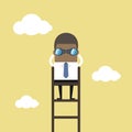 African businessman on a ladder using binoculars above cloud. Royalty Free Stock Photo