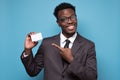 African businessman pointing finger at blank business card with space for tex Royalty Free Stock Photo