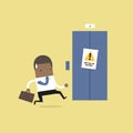 African businessman are running to the elevator. But the elevator is out of service. Royalty Free Stock Photo