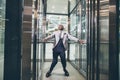 African Businessman screaming in elevator. fear claustrophobia concept