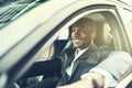 African businessman smiling while driving his car in the city Royalty Free Stock Photo