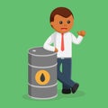 African businessman standing beside oil drum