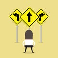 African businessman standing on three way arrows road sign. Royalty Free Stock Photo