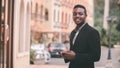 African businessman in suits use mobile phones happily in the city.Business and technology concept