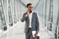 African Businessman Talking On Cellphone Going On Trip In Airport Royalty Free Stock Photo