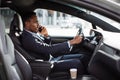 African businessman talking on mobile while driving car Royalty Free Stock Photo