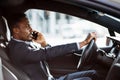 African businessman talking on mobile while driving car Royalty Free Stock Photo