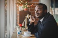 African businessman thinking and looking out the window worried about business in coffee shop Royalty Free Stock Photo