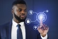 African Businessman Touching Virtual Panel For Fingerprint Scanning, Blue Background