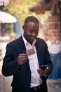 African businessman using a credit card payment shopping online on his Smart Phone Royalty Free Stock Photo