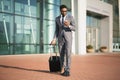 African Businessman Using Smartphone Waiting For Flight Standing At Airport