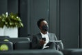 African Businessman Wearing Mask in Lobby Royalty Free Stock Photo