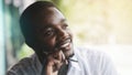 African businessman in white shirt looking out the window with smile and happy, thinking about new project.Black man sits and Royalty Free Stock Photo