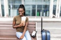 African pretty businesswoman with air ticket at airport waiting for flight Royalty Free Stock Photo