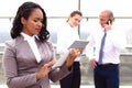 African businesswoman businessman holding a tablet in hand standing outdoor