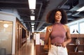 African businesswoman standing with arms crossed smiling to camera Royalty Free Stock Photo