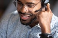 African call center operator wears headset contacting with customers closeup