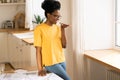 African casual woman talk on phone on loudspeaker at home. Young black girl record voice message Royalty Free Stock Photo