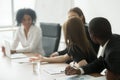 African and caucasian colleagues brainstorming sharing ideas sit