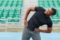 African cheerful sportsman doing side bends Royalty Free Stock Photo