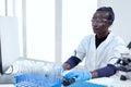 African chemist typing rapport about virus study