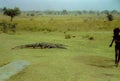 An African child with a crocodile at the Paga Crocodile Pond near Paga, Ghana c.1958