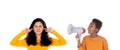 African child with a megaphone and a teenager girl covering her ears