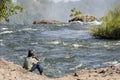 African Child setting on Zambezi river side on top of Victoria falls , Livingstone , Zambia