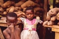 African children with an array of fresh fruits and vegetables in the background in Abidjan